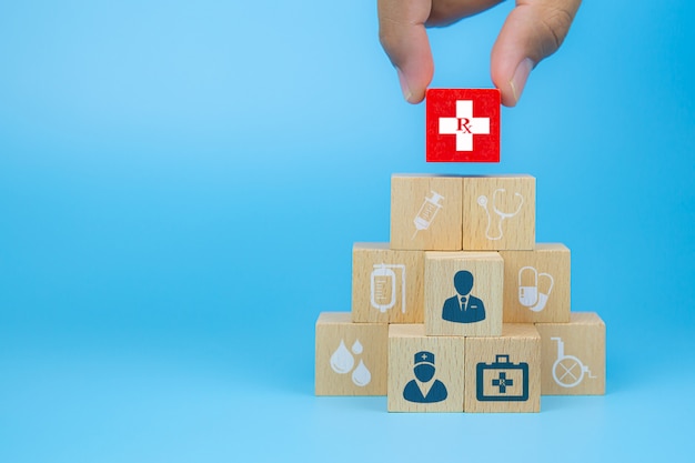 Lekarka i pacjent na sześcianów drewnianych zabawkarskich blokach z medyczną ikoną