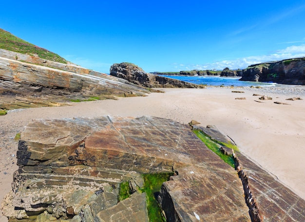 Letni krajobraz wybrzeża Atlantyku z plaży i formacje skalne (Praia Das Illas, Hiszpania).