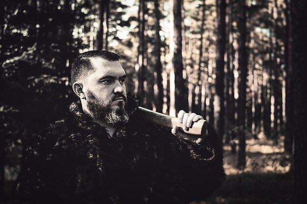 Zdjęcie Łowca z bronią stojącego w lesie