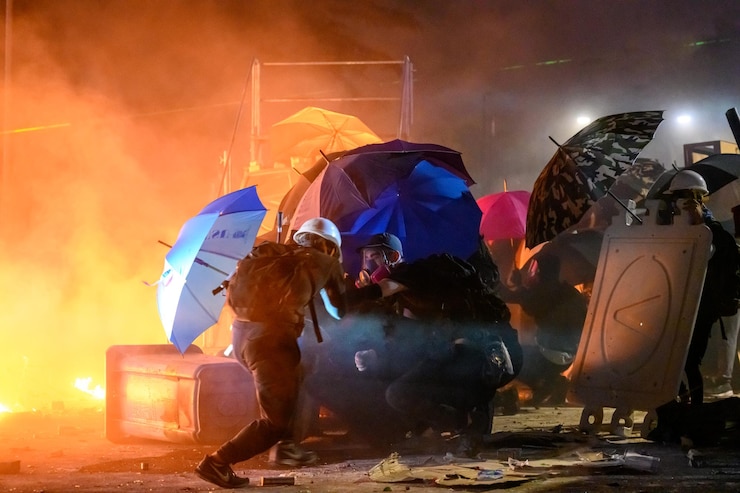 Zdjęcie ludzie protestują na ulicach miasta w nocy.