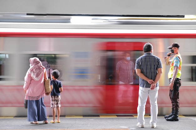 Ludzie stojący obok jadącego pociągu w tle na stacji kolejowej Yogyakarta, 1 marca 2023 r