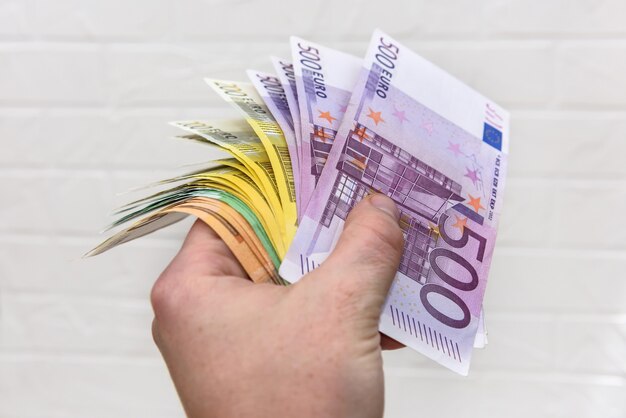 Ludzka ręka z banknotami euro z bliska