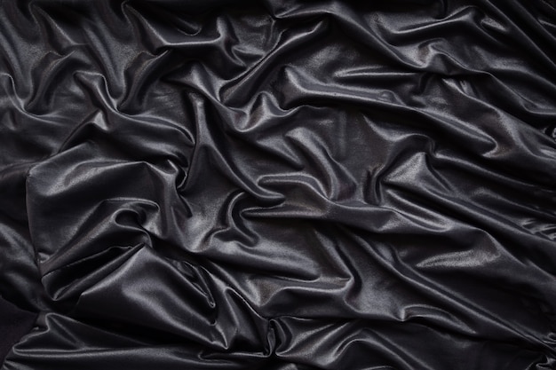 Luksusowy czarny jedwabny satynowy materiał leżał płasko w tle.