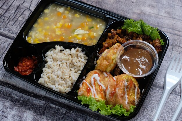 lunch box zdrowej żywności bento z brązowym ryżem, jajecznicą, zupą kukurydzianą, tempeh tofu. menu dietetyczne.