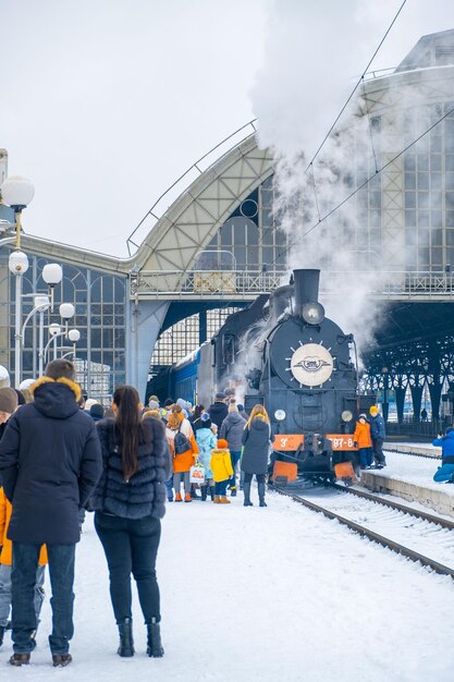 Lwów, Ukraina - 9 stycznia 2022: ludzie turyści w pobliżu starej atrakcji pociągu macierzystego