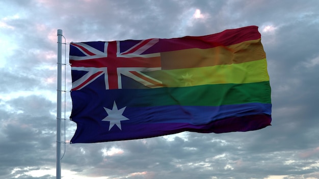 Macha flagą narodową Australii i tęczową flagą LGBT