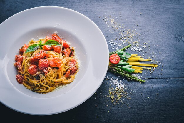 Makaron pomidory Włoskie tradycyjne jedzenie Na drewnianym tle Widok z góry Wolne miejsce na tekst