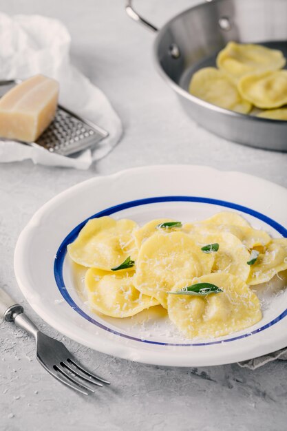 Makaron ravioli kuchni włoskiej z parmezanem i szałwią