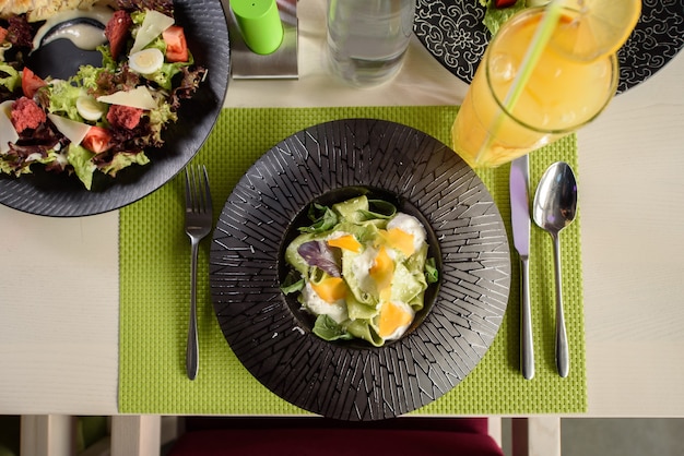 Makaron Ze Szpinakiem, Serem I Bazylią Na Czarnym Talerzu, Widok Z Góry. Piękne Danie Restauracyjne. Nakrycie Stołu.