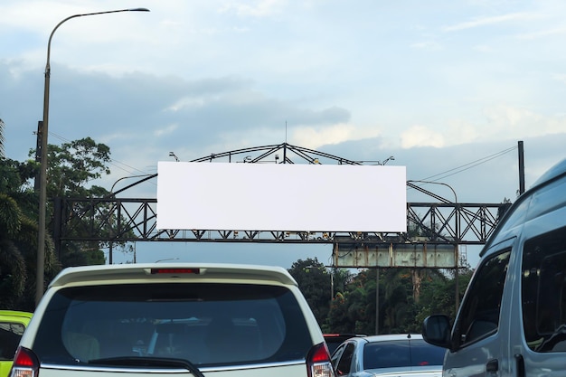 Makieta billboardu na środku drogi z atmosferą ruchu pod pięknym niebem