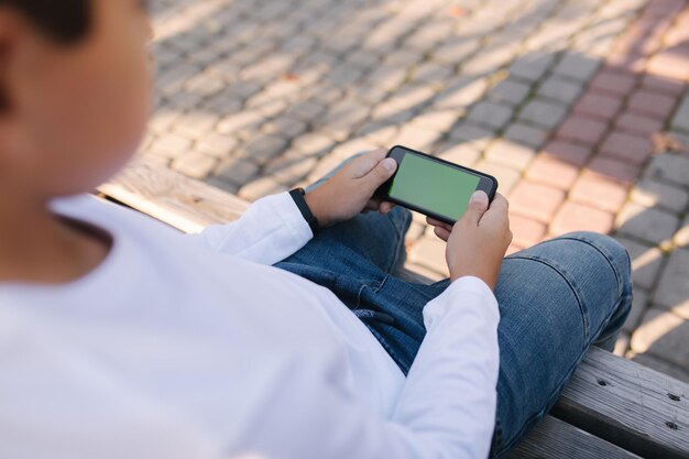 Makieta chłopca grającego w gry na smartfonie Bay trzymaj telefon poziomo Zielony ekran