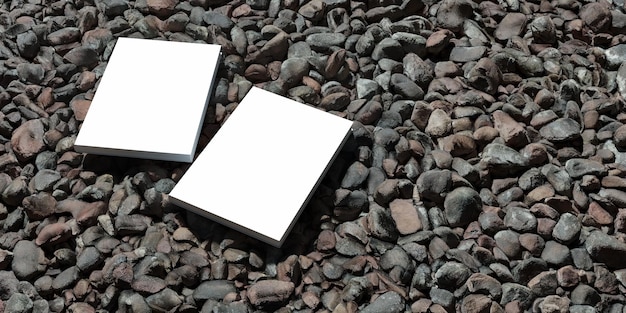 Zdjęcie makieta pustej książki umieszczona na żwirze, makieta notebooka, makieta na tle przyrody 02