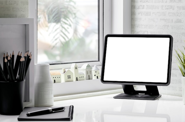 Makieta tabletu z pustym ekranem na stojaku w nowoczesnym pokoju z miejscem na kopię.