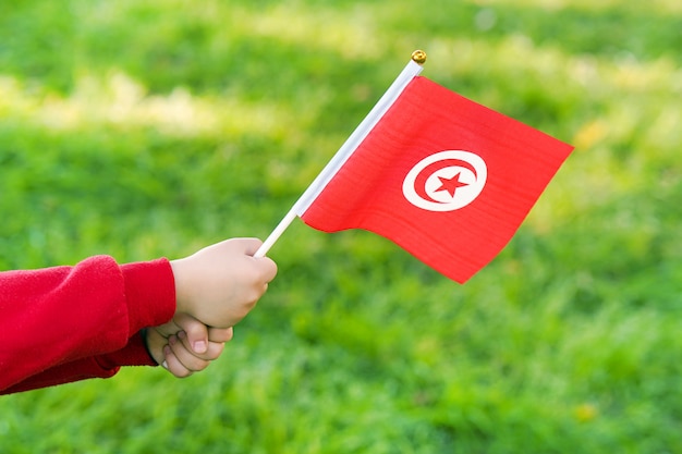 Mała dziewczynka ręce trzymać flagę Tunezji
