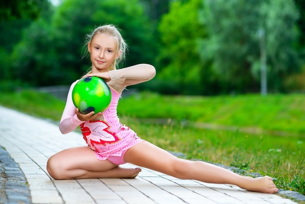 Zdjęcie mała dziewczynka sportowa ćwiczeń w parku