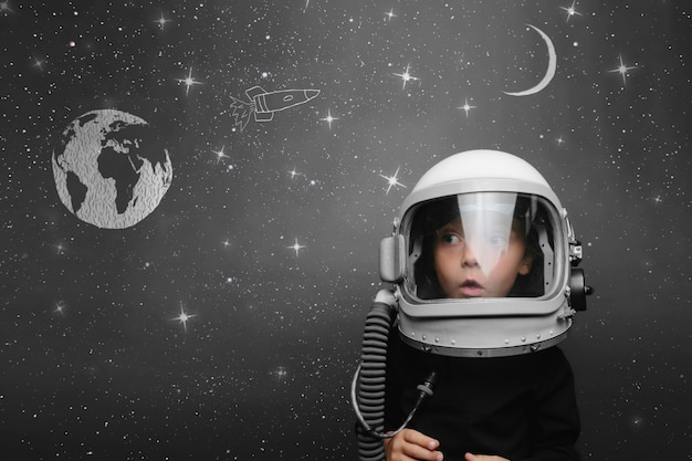 Małe dziecko chce latać w kosmosie w hełmie astronauty