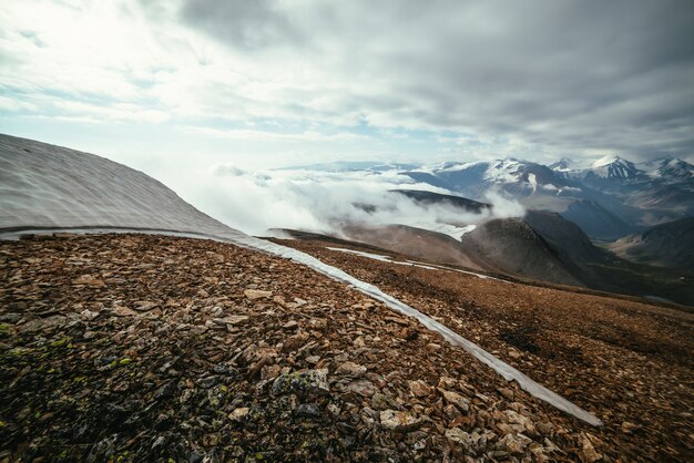 Malowniczy alpejski krajobraz z warstwami gór po horyzont w gęstych niskich chmurach