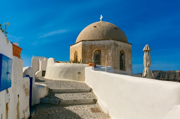 Malowniczy widok na białe domy i kościół w Oia lub Ia, wyspa Santorini, Grecja