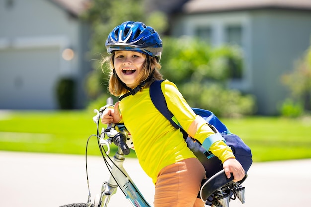 Mały chłopiec jeździ rowerem w letnim parku. Dziecko jeździ rowerem na podjeździe.