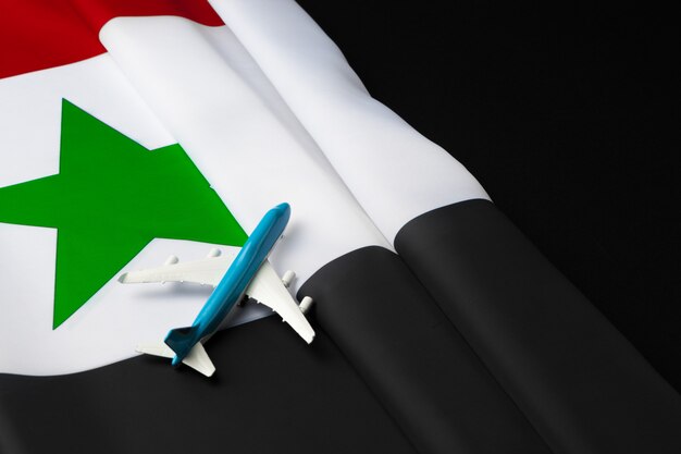 Mały samolot-zabawka nad flagą z Syrii
