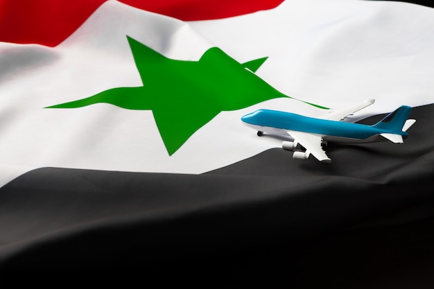 Mały samolot-zabawka nad flagą z Syrii