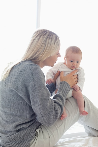 Mama siedzi z dzieckiem na kolanach