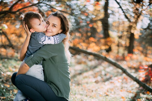 Mama z synem trzy lata jesienią las, uścisk i czułość