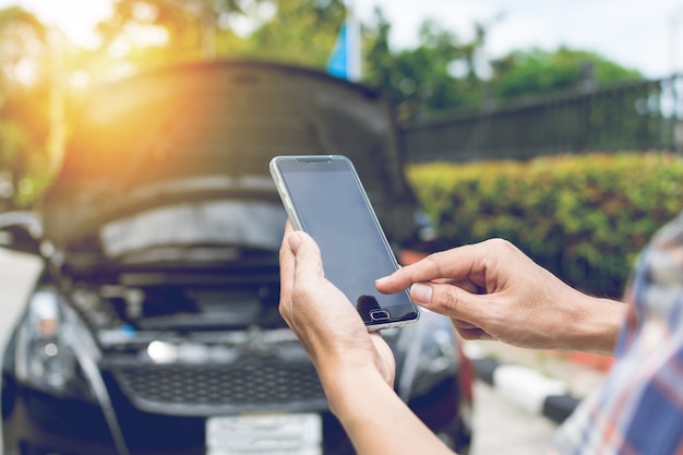 Man Phoning For Help With A Broken Down Car