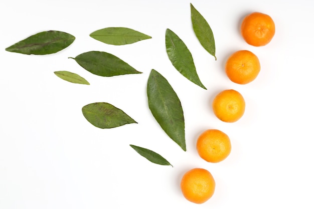 Zdjęcie mandarynka z liśćmi na białym tle. zdrowe świeże warzywa i żywność