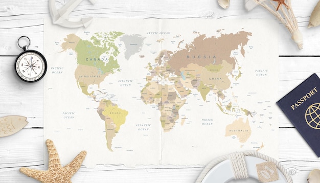 Zdjęcie mapa świata kompas paszport i muszle koncepcja planowania podróży widok z góry białe drewniane biurko