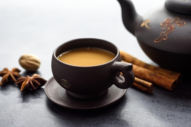 Masala herbata w glinianym kubku i czajniku tradycyjny indyjski gorący napój