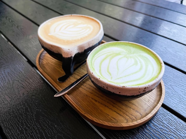 Zdjęcie matcha latte i kawa późna sztuka stoisko na drewnianej tacy na czarnym stole odżywianie ziołowe espresso kremowe aromatyczne barista kofeina ceramiczna łyżka smak natura