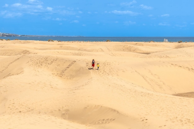 Matka z dzieckiem spacerują na wakacjach letnich po wydmach Maspalomas Gran Canaria Wyspy Kanaryjskie