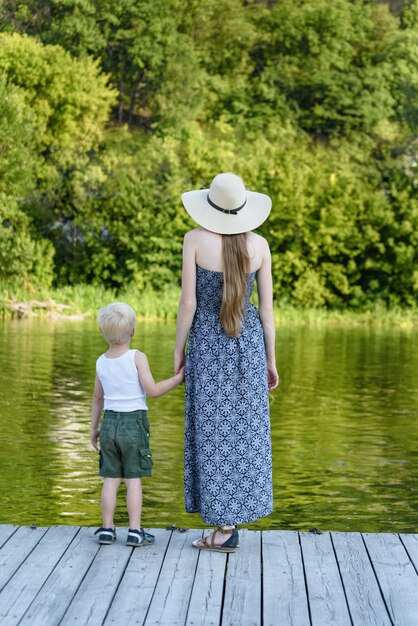 Matka z synkiem stoją na molo nad rzeką