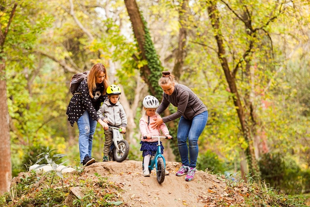 Matki uczące i wspierające swoje dzieci podczas jazdy na rowerze