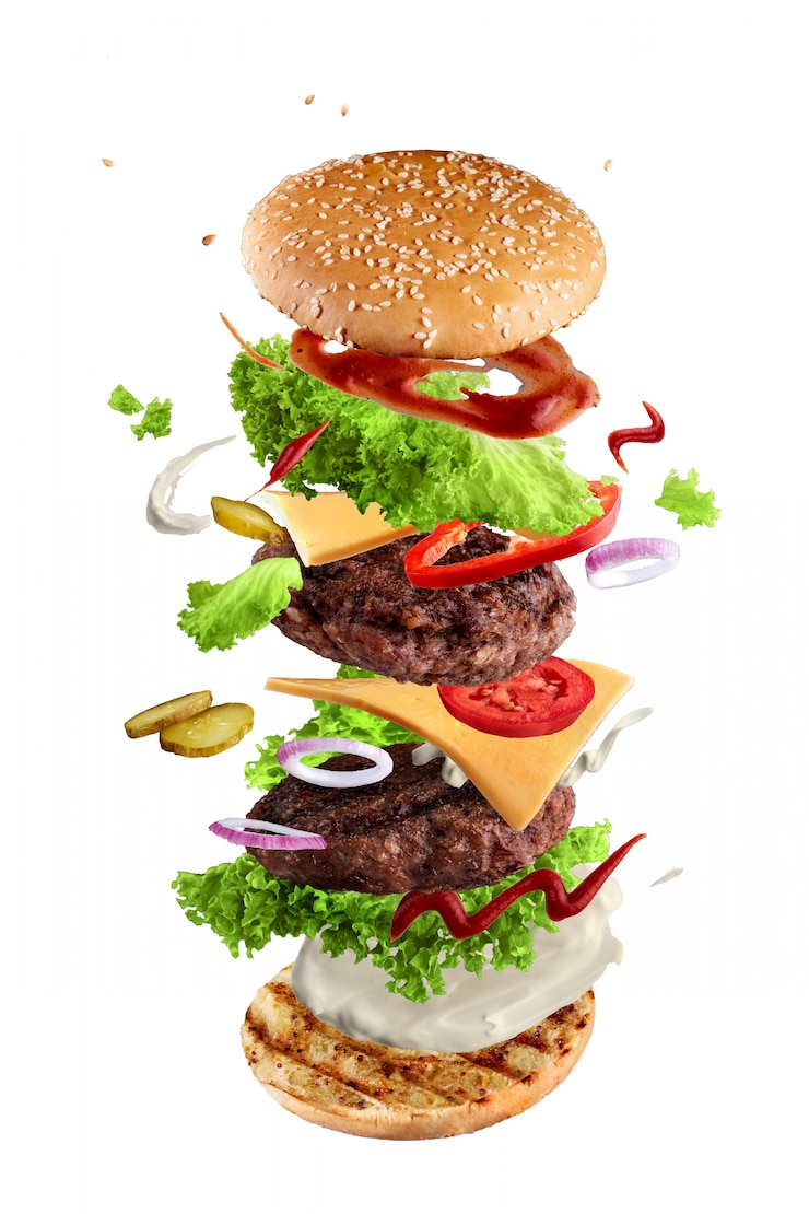 Zdjęcie maxi hamburger, podwójny cheeseburger z latającymi składnikami odizolowywającymi na bielu