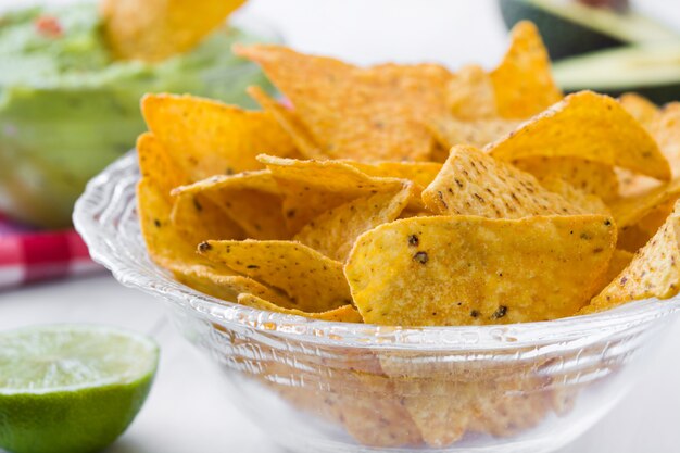 Meksykańskie guacamole z nachos na białym drewnianym stole