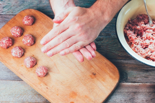 Męskie dłonie przygotować domowe kulki mięsne zbliżenie widok z góry