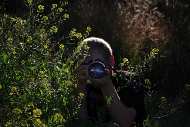 Zdjęcie mężczyzna fotografujący wśród roślin