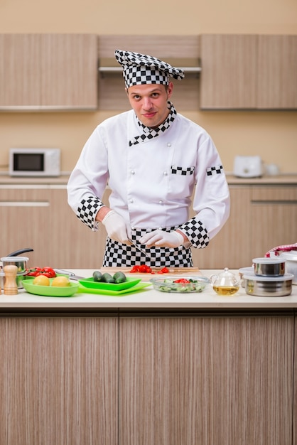 Mężczyzna kucharz przygotowuje jedzenie w kuchni