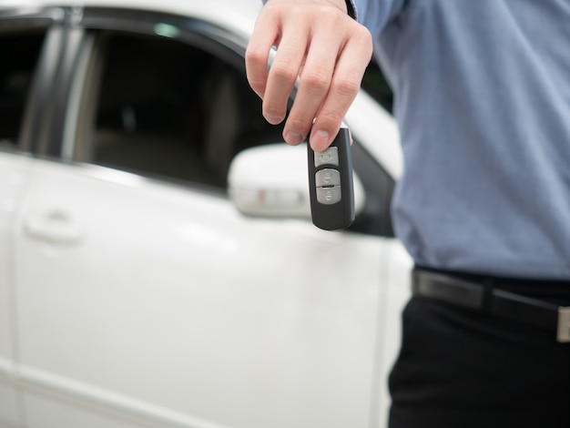 Mężczyzna mienia klucz w nowożytnym auto przedstawicielstwie handlowym. Zamyka w górę ręki daje samochodu kluczowi klient kardealer