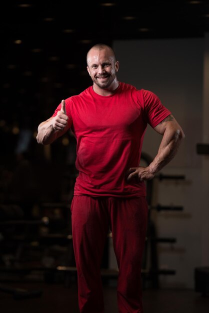 Mężczyzna Stojący Silny Na Siłowni Pokazuje Kciuki W Górę Mięśni Atletyczny Kulturysta Model Fitness Pozuje Po Ćwiczeniach
