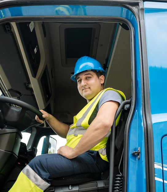 Mężczyzna technik siedzi na siedzeniu kierowcy w ciężarówce