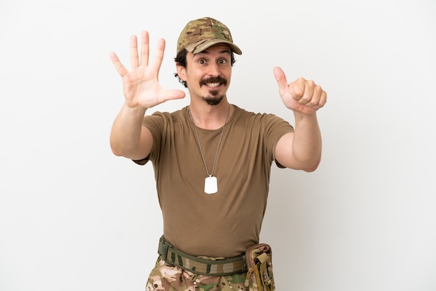 Mężczyzna żołnierz na białym tle licząc sześć palcami