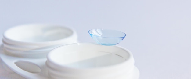 Zdjęcie miękkie soczewki kontaktowe i biała plastikowa skrzynia z selektywnym ostrościem