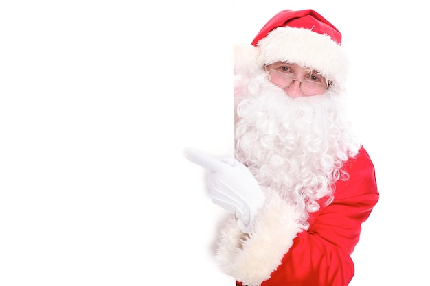 Miły Święty Mikołaj wskazując w biały pusty znak, izolowana na białym tle