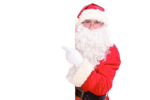 Miły Święty Mikołaj wskazując w biały pusty znak, izolowana na białym tle