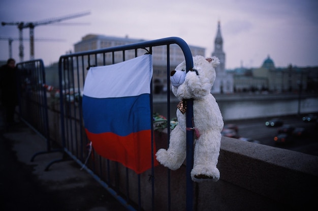 Zdjęcie misiak i rosyjska flaga na barykadzie przed budynkami w mieście