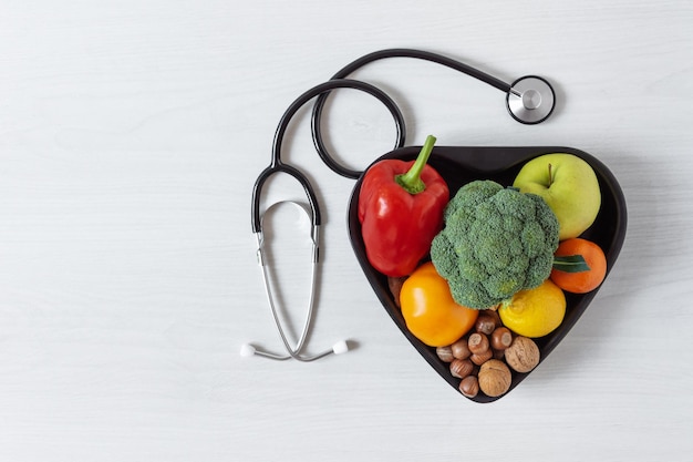 Miska W Kształcie Serca Z Warzywami, Owocami, Orzechami I Stetoskopem Koncepcja Zdrowego Odżywiania