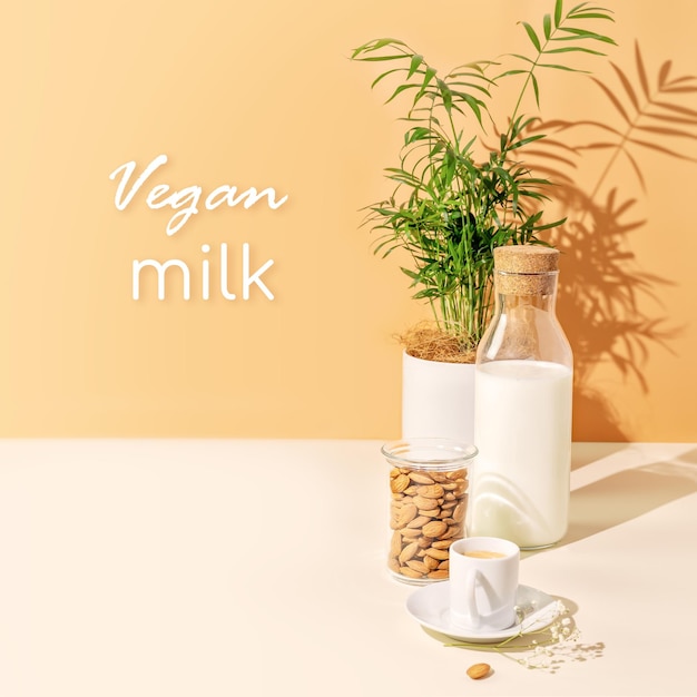 Mleko migdałowe bez laktozy Puchar mleka roślinnego z migdałami na białym tle z tekstem Mleko wegańskie